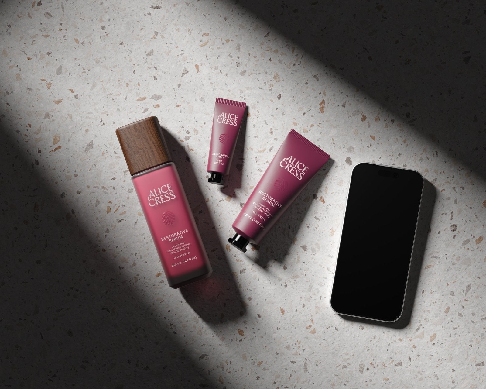 Alice Cress serum in three sizes beside a phone